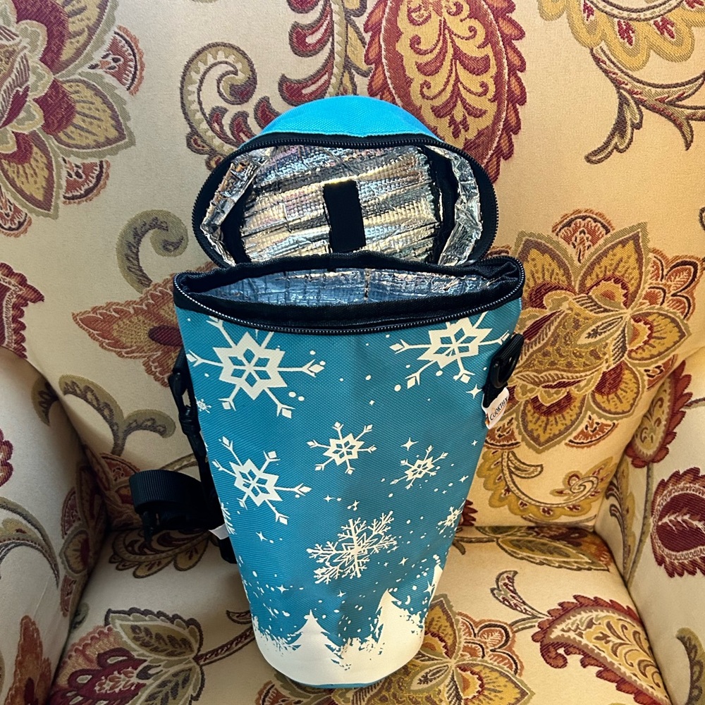 Insulated beverage holder with adjustable strap.